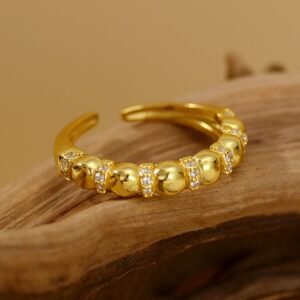 a sterling silver gold plated ring with zircon on a piece