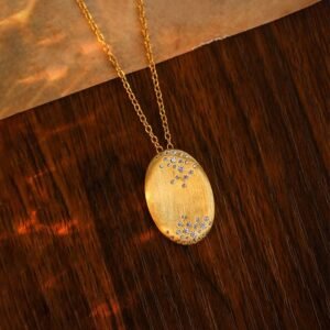 Gold-Plated Silver Oval Pendant Necklace on the table