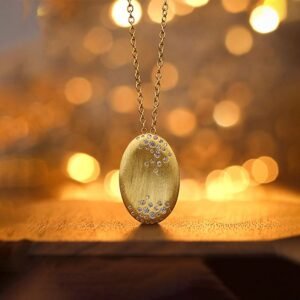 Gold-Plated Silver Oval Pendant Necklace on the table