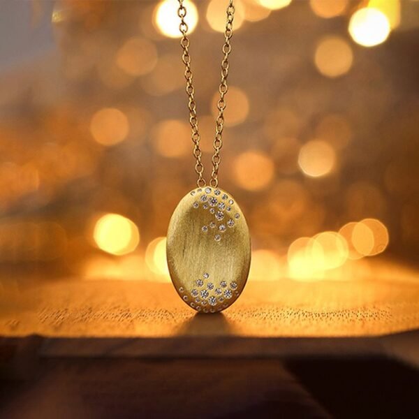 Gold-Plated Silver Oval Pendant Necklace on the table